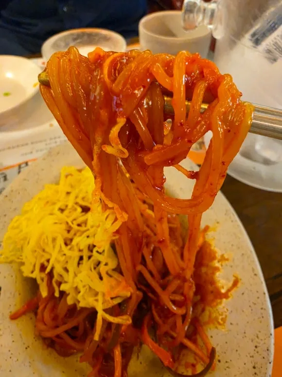Chewy jjolmyeon noodles coated in spicy red sauce