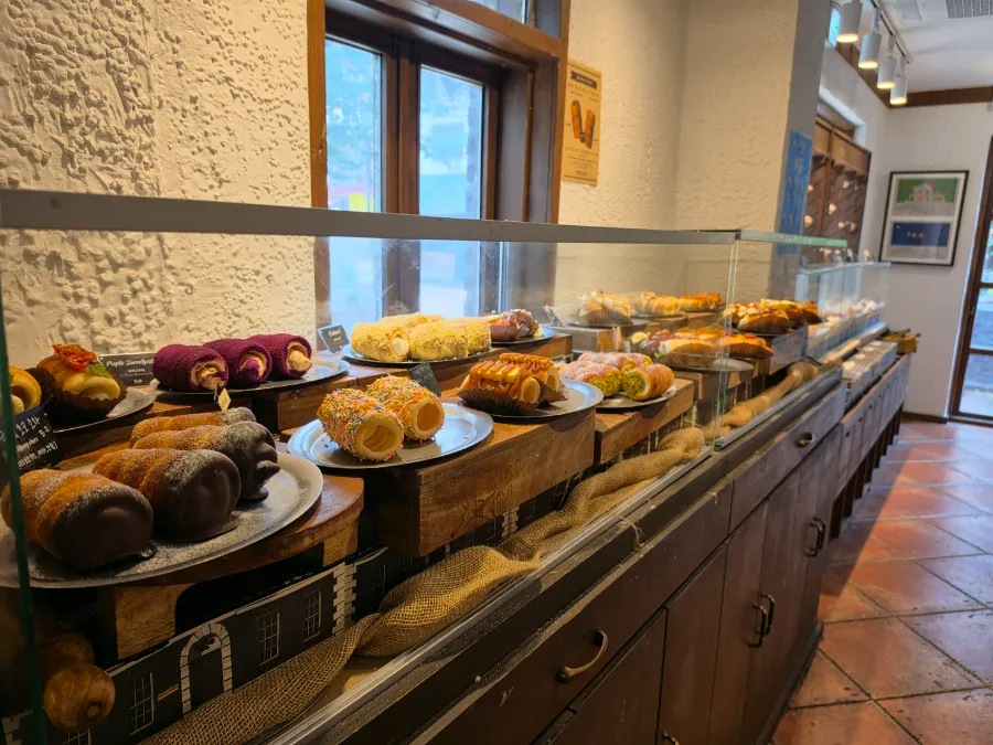 Assorted chimney cakes on display at Chimney Mansion in Hongdae