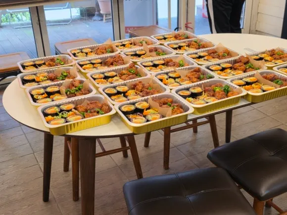 Kimbap and Korean fried chicken catering boxes in Seoul