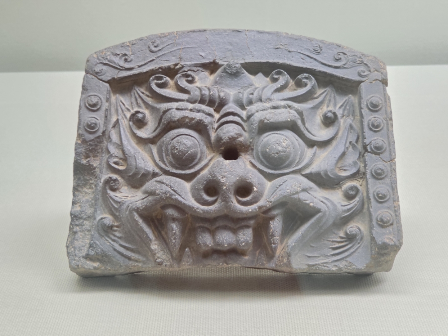 Traditional Korean roof tile with a fierce monster face