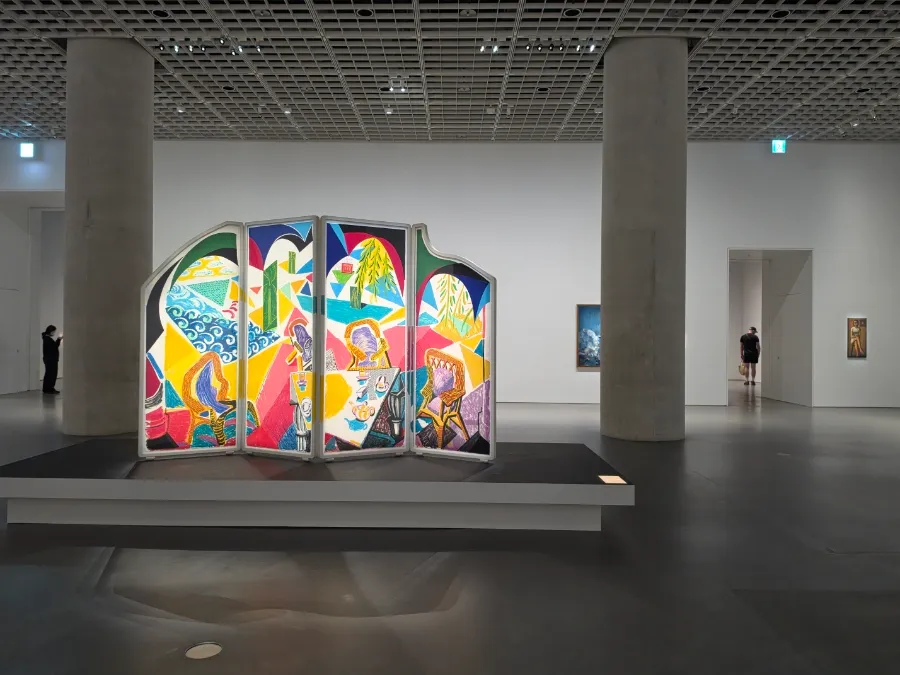Colorful folding-screen-shaped artwork on a raised platform inside the Amorepacific Museum of Art.