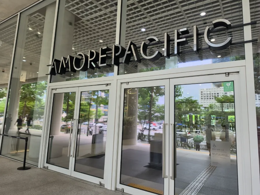 Glass entrance doors beneath the AMOREPACIFIC sign at the company’s headquarters in Yongsan, Seoul.