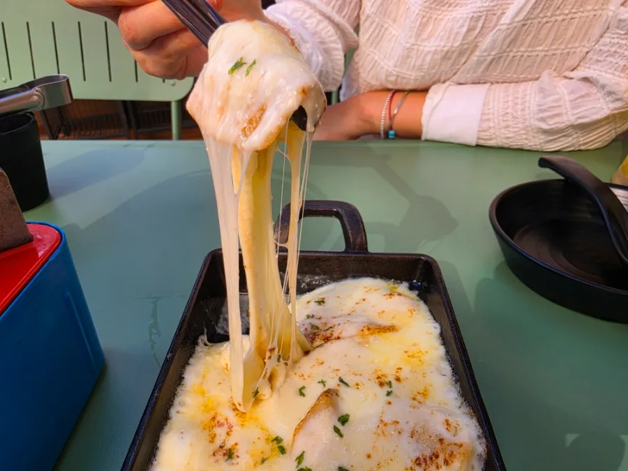 Mentaiko cheese potatoes with melted cheese at Hanamato Hyehwa izakaya.