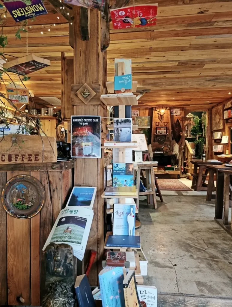 Wooden walls, bookshelves and book displays inside Manhole Coffee Western Book Cafe in Seoul.
