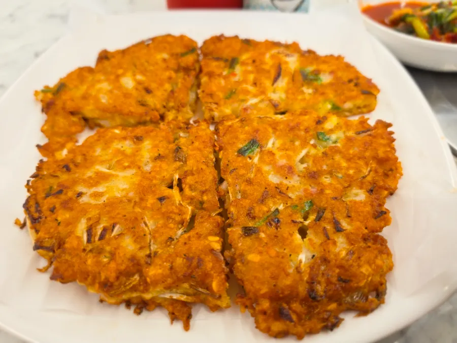 Crispy Korean meat bindaetteok mung bean pancake in Seoul