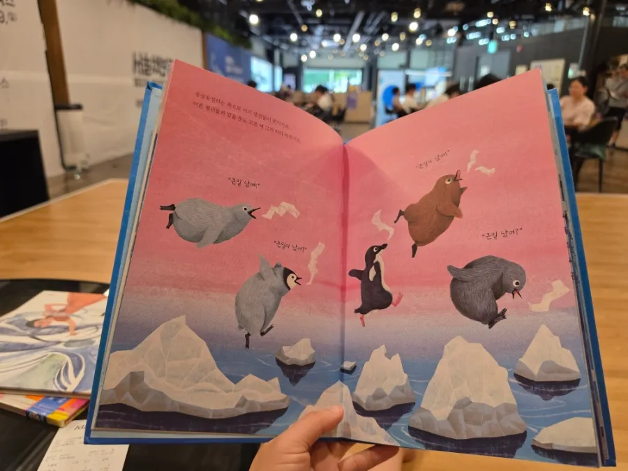 Reading a Korean picture book at Seoul Book Bogo