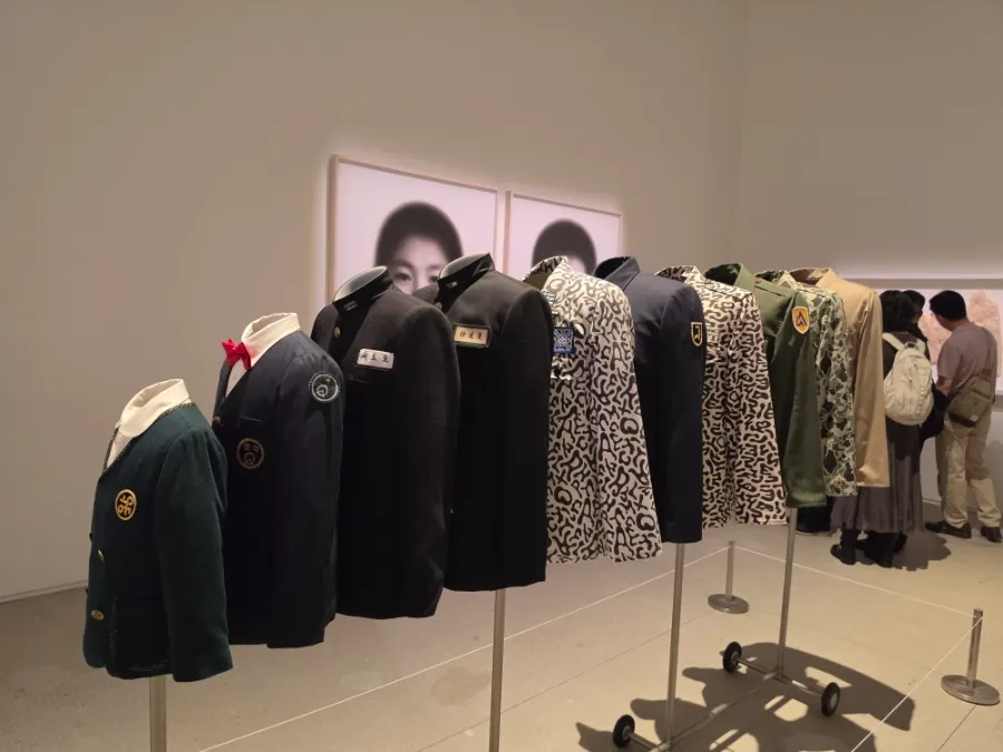 School uniforms and military clothing displayed at the Do Ho Suh exhibition