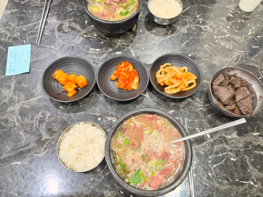 Yuchi Hoegwan haejangguk with rice, kimchi and Korean side dishes in Suwon
