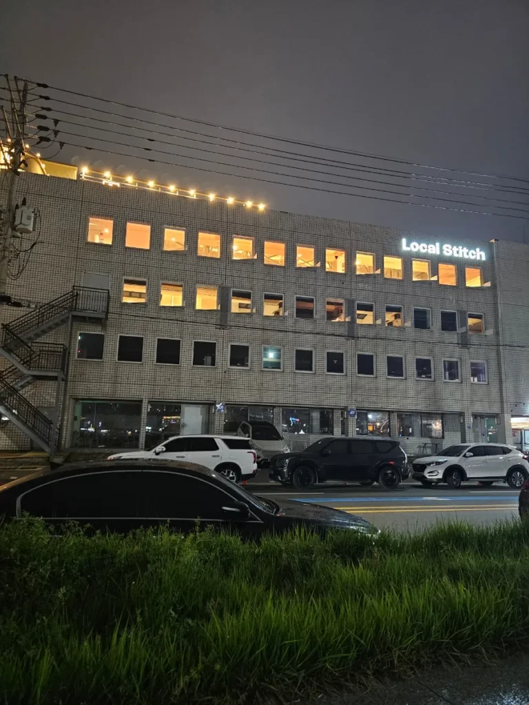 Exterior of Local Stitch Tongyeong with illuminated windows at night