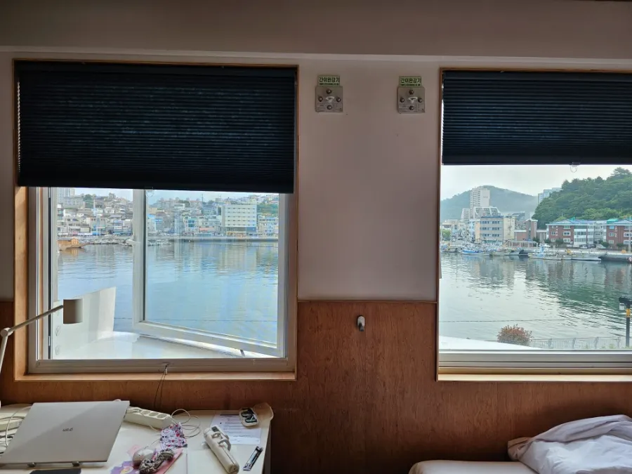 Gangguan Harbor seen through the guest room windows at Local Stitch Tongyeong